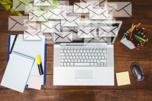 composite image of high angle view of business desk with letter icons